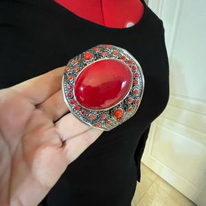 Costume jewelry bracelet. Red tone stones on silver tone. Never worn.